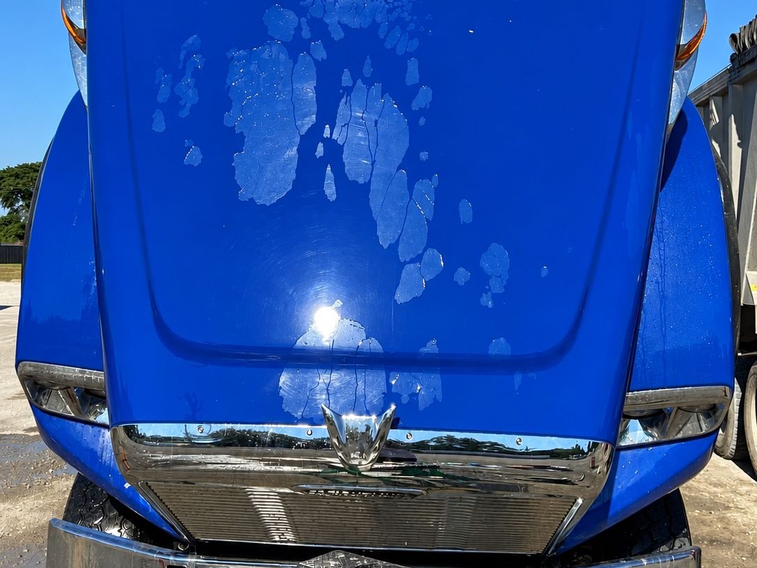 Blue truck with the hood raised, glossy deep blue with a polished chrome bumper.